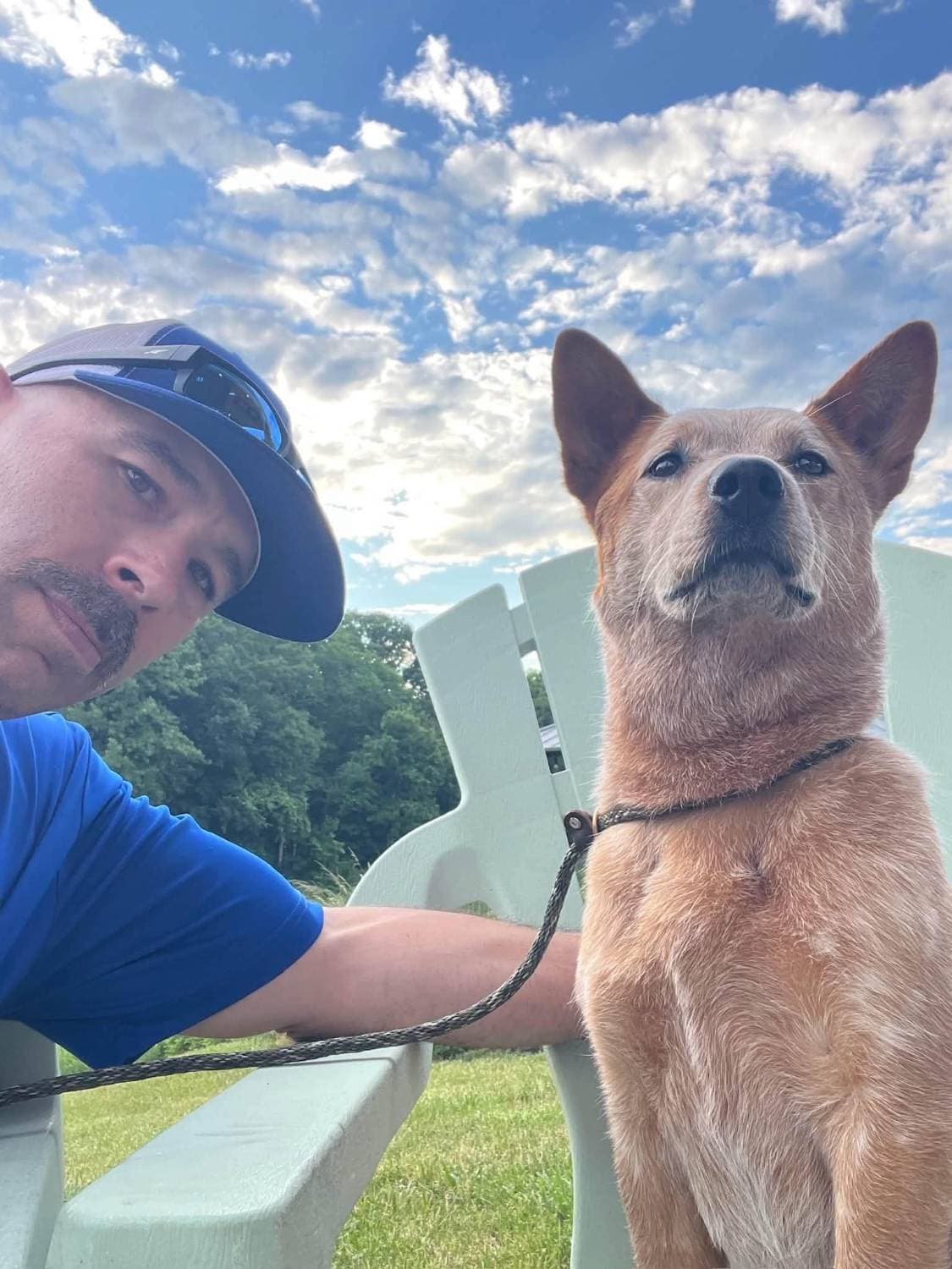 Trevor and Spring sitting together outside under a blue sky